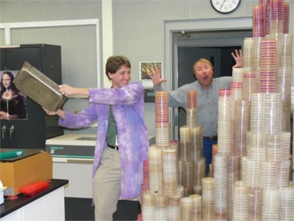 Biologist Richard Lenski (right) and his colleague Zachary Blount, in front of hundreds of lab plates used to grow bacteria.
